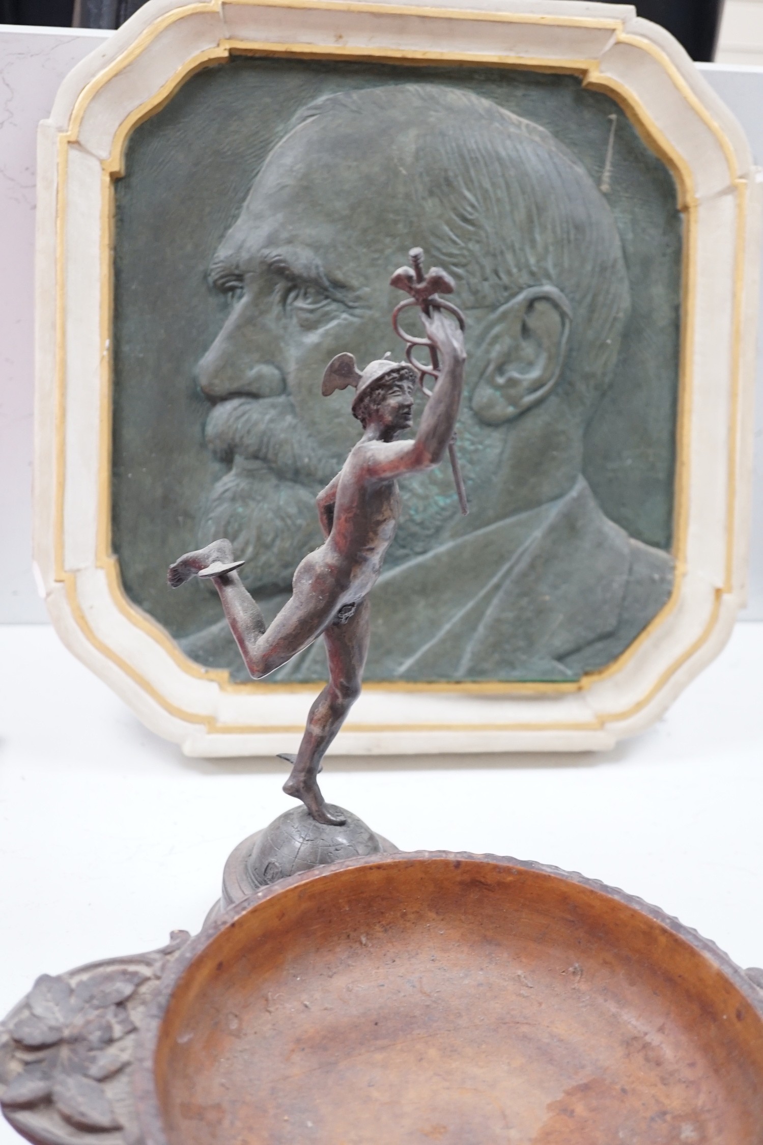 A Spelter figure of Mercury, a musical Black Forest carved wooden bowl, a Chinese carved wood vase stand, two Persian scribes boxes and a painted bronzed plaster plaque (6)